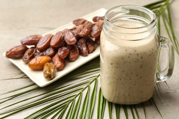 Mason jar of smoothie with dates on table