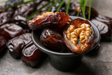 Bowl with sweet dried dates on table