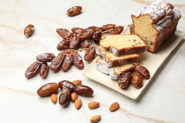 Tasty cake with dates on table