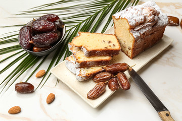 Tasty cake with dates on table
