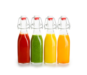 Bottles of healthy vegetable juice on white background