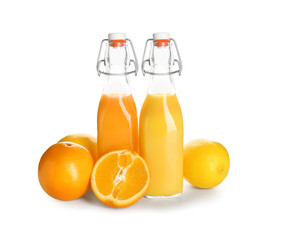 Bottles of healthy fruit juice on white background