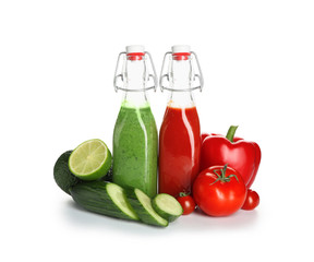 Bottles of healthy vegetable juice on white background