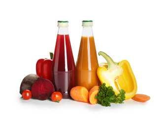 Bottles of healthy vegetable juice on white background