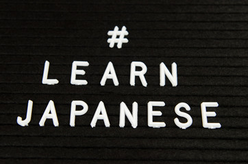 Learn Japanese JPN abbreviation, simple sign on black background, great for teachers, schools, students