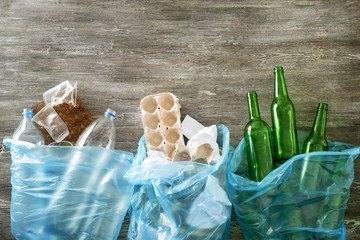 Different sorted trash on wooden background. Recycle concept