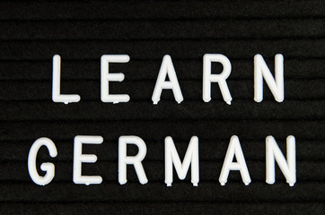 Learn German, GER abbreviation, simple sign on black background, great for teachers, schools, students