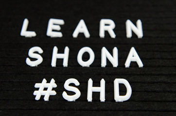 Learn Shona Zimbabwe language, SHD abbreviation, simple sign on black background, great for teachers, schools, students