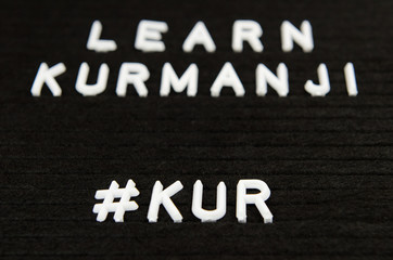 Learn Northern Kurdish Kurmanji language, KUR abbreviation, simple sign on black background, great for teachers, schools, students