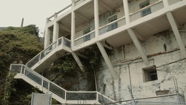 Tilt down shot of Corner wall on Alcatraz Island prison building, low angle