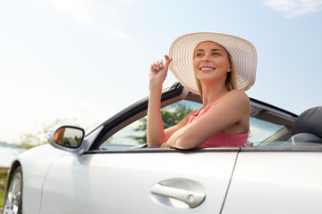 travel, summer holidays, road trip and people concept - happy young woman wearing hat in...