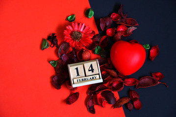Topview wood calendar on 14 February and heart decoratewith dry flower on red with black background, love concept.