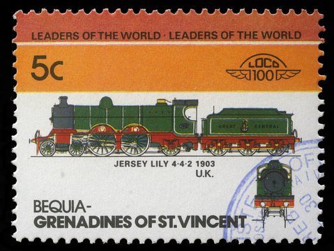 Stamp printed in Grenadines of St. Vincent shows Jersey Lily Train 4-4-2, 1903 U.K., circa 1985