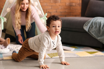 Cute little boy with mother playing at home © Pixel-Shot