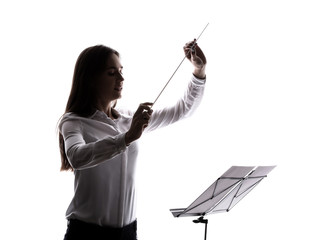 Silhouette of young orchestral conductor on white background
