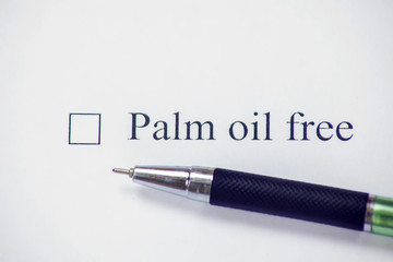 Checklist box with words palm oil free and pen on white paper. Check form concept