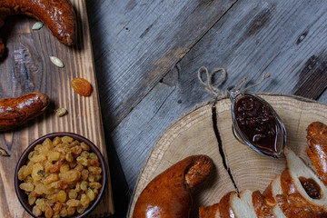 Still life with bread, nuts, fruits and jam on colored wood background.