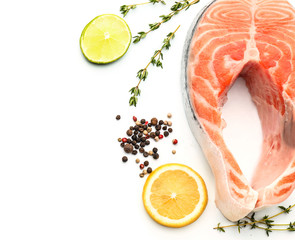 Piece of fresh salmon with spices on white background