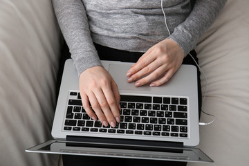 Fototapeta na wymiar Woman working on modern laptop at home