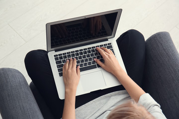 Fototapeta premium Woman working on modern laptop at home