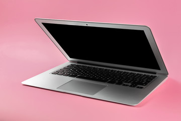 Modern laptop on color background