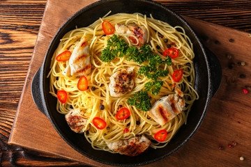 Tasty pasta with chicken and vegetables in frying pan
