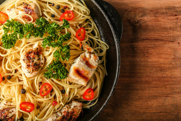 Tasty pasta with chicken and vegetables in frying pan