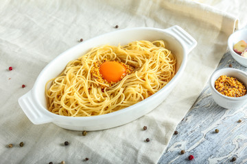 Dish with tasty pasta and egg on table