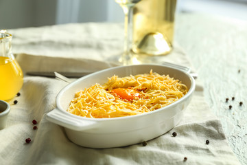 Dish with tasty pasta and egg on table