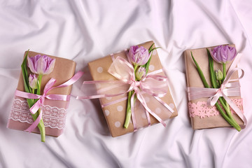 Handmade gift boxes with flowers on white cloth
