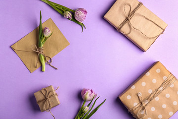 Composition with beautiful gift boxes and flowers on color background