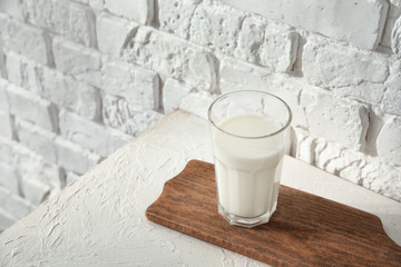 Glass of milk on white table