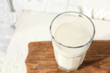 Glass of fresh milk on table