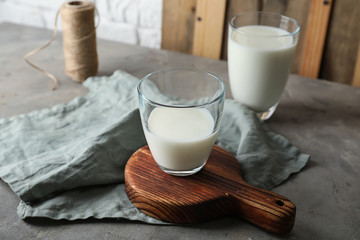 Glasses of fresh milk on table
