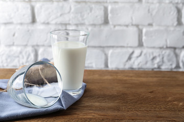 Glass of fresh milk on wooden table