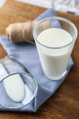 Glass of fresh milk on wooden table