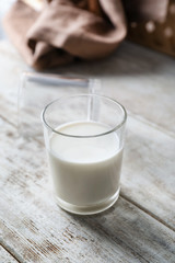 Glass of fresh milk on wooden table