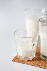 Glasses of fresh milk on white background