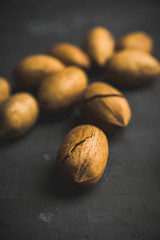 Delicious pecan nuts on the rustic wooden background. Selective focus. Shallow depth of field.