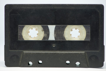 Obraz premium A black cassette tape on a white background