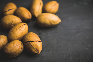 Delicious pecan nuts on the rustic wooden background. Selective focus. Shallow depth of field.