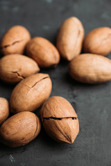 Delicious pecan nuts on the rustic wooden background. Selective focus. Shallow depth of field.