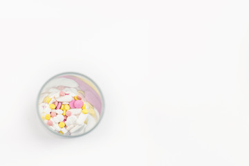 glass full of colorful medicines,pills, vitamins or supplements. The concept of addiction treatment