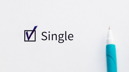 Single - checkbox with a tick on white paper with blue pen. Checklist concept.