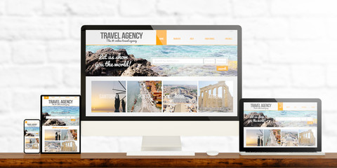 responsive travel agency website devices on wooden desktop