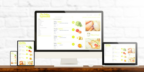 online supermarket website devices on wooden desktop