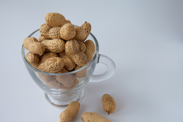 peanuts in a shell in a glass cup