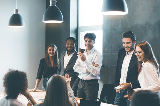 Business people having break and talking at meeting
