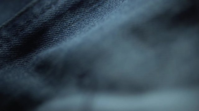 Macro shot of denim material and buttons used for jeans and jackets in the manufacturing of designer denim clothing
