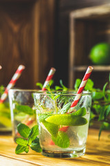 Mojito cocktail in a bur on a rustic table